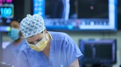 Clinician in operation room with mask and protective equipment on