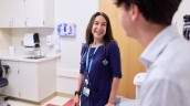 Clinician speaks with adolescent in clinical setting