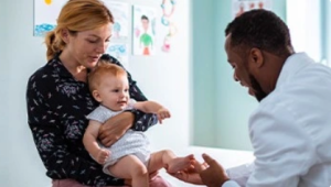 Physician attending to mother and child
