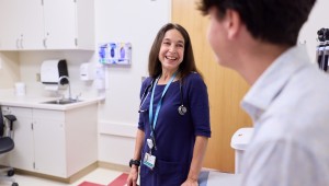 Clinician speaks with adolescent in clinical setting