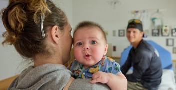 Family in hospital room with baby