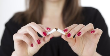 Women breaking cigarette in half