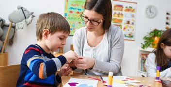 Boy and teacher in a classroom setting
