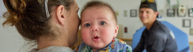 Family in hospital room with baby