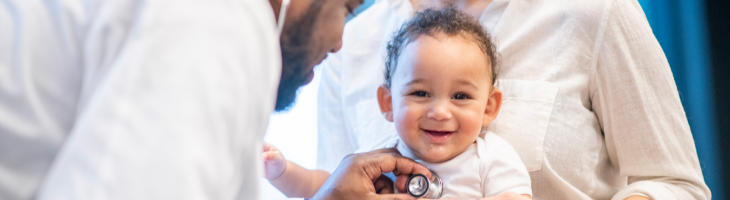 Clinician uses stethoscope to check infant