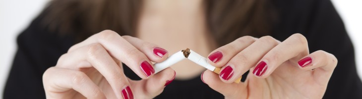 Women breaking cigarette in half