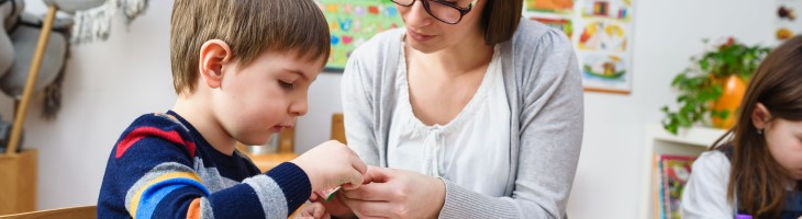 Boy and teacher in a classroom setting