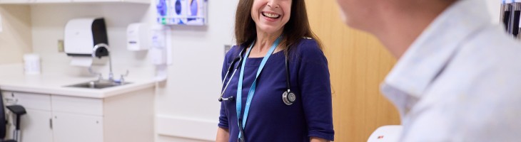 Clinician speaks with adolescent in clinical setting