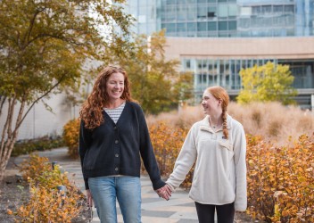 Woman and child walking hand in hand.