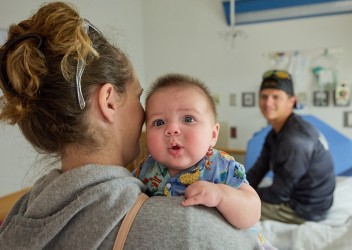 Family in hospital room with baby