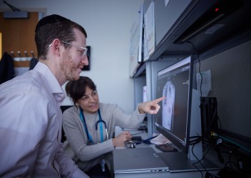 Clinicians examining chest x-ray
