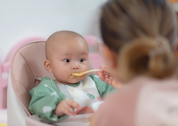 Baby in Highchair eating