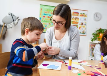 Boy and teacher in a classroom setting